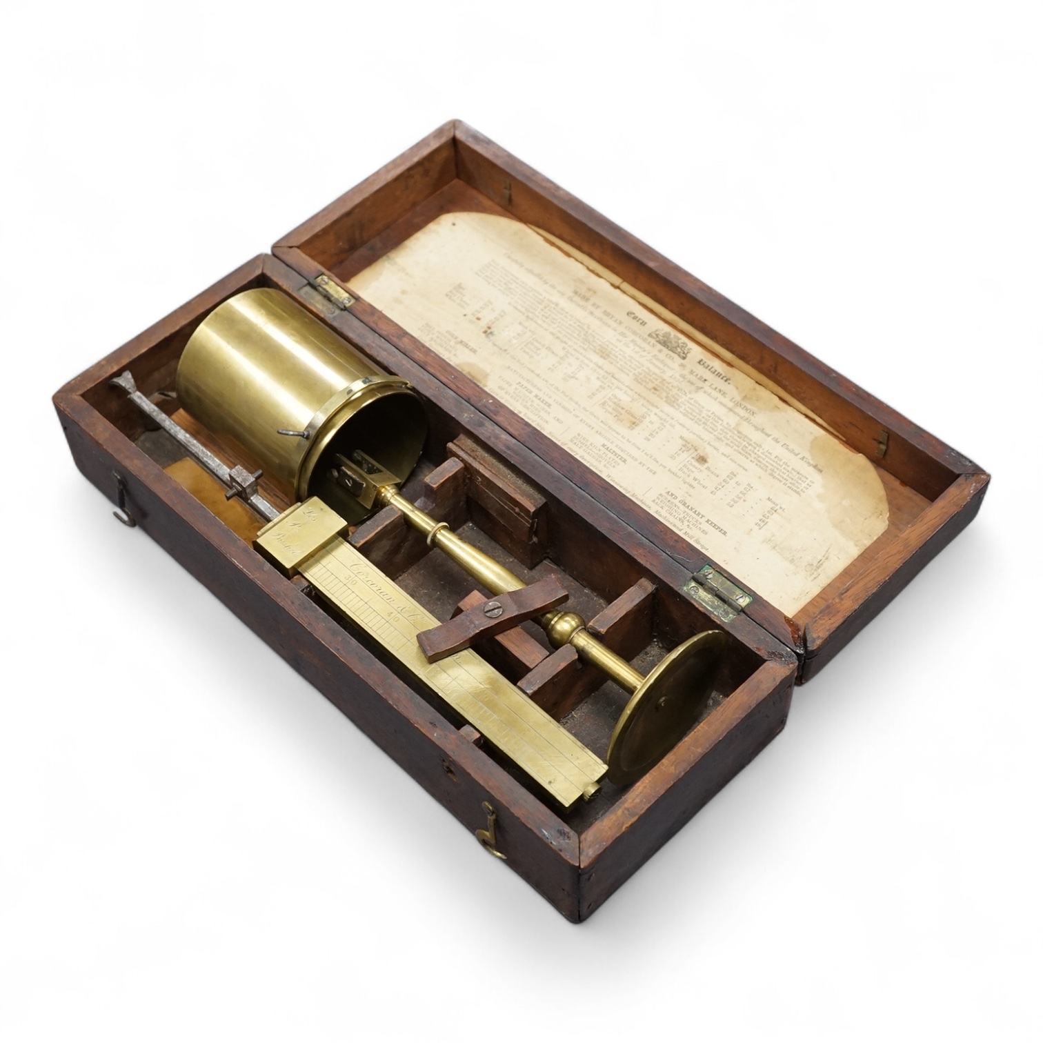 A 19th century mahogany cased brass Corn Balance, made by Bryan Corcoran & Co., 36, Mark Lane, London, with engraved scale and sliding balance marked with; ‘Lbs Per Bushel’, in its original fitted case with paper label t